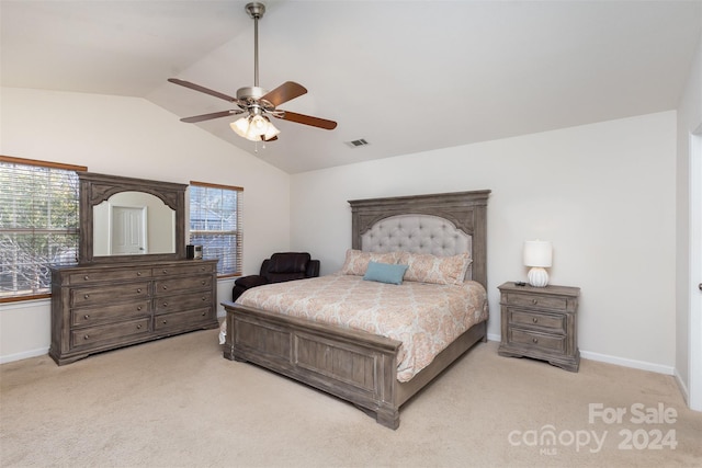 bedroom with ceiling fan, light colored carpet, and vaulted ceiling