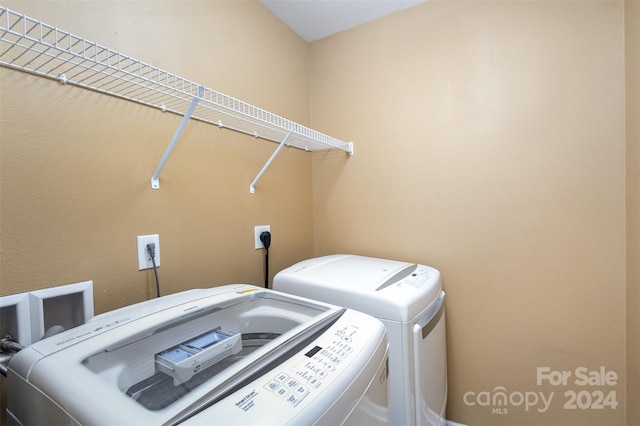 washroom with independent washer and dryer