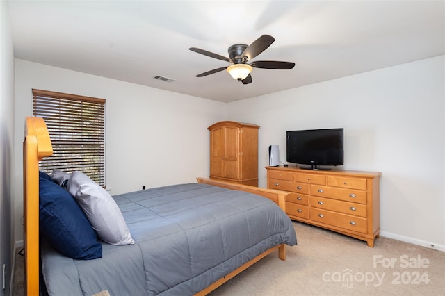 bedroom with light colored carpet and ceiling fan