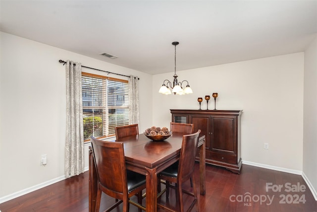 dining area featuring a notable chandelier and dark hardwood / wood-style flooring