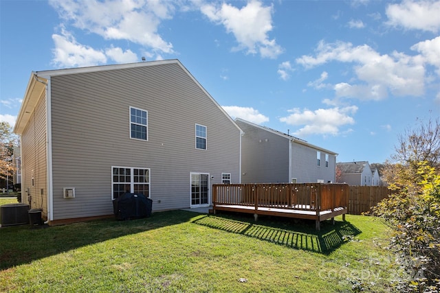 back of house featuring a lawn, central AC unit, and a deck