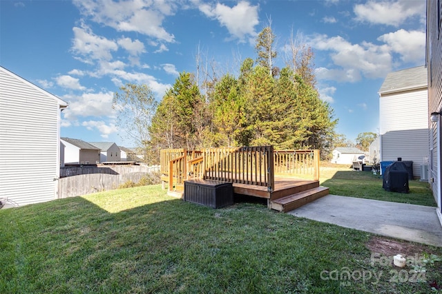 view of yard with a patio area and a wooden deck