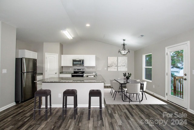 kitchen featuring white cabinetry, a center island with sink, vaulted ceiling, and appliances with stainless steel finishes