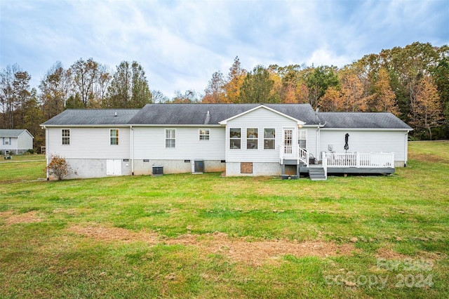 back of house with a wooden deck, cooling unit, and a lawn