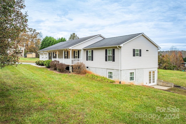 rear view of house with a yard and a porch