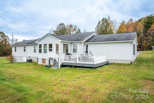 back of house featuring central AC, a lawn, and a wooden deck