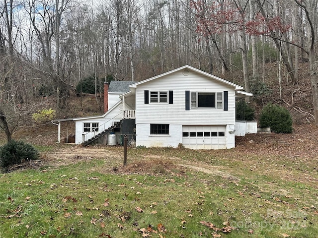 view of home's exterior with a lawn and a garage