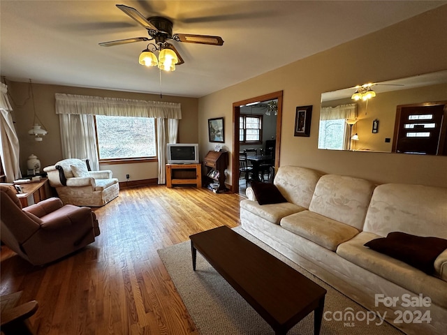 living room featuring hardwood / wood-style flooring and ceiling fan