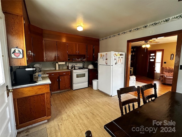 kitchen featuring tasteful backsplash, white appliances, ceiling fan, and light hardwood / wood-style flooring