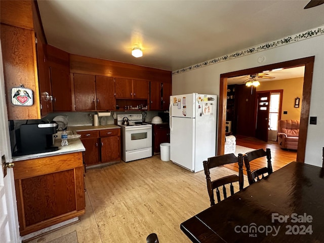 kitchen with tasteful backsplash, white appliances, ceiling fan, and light hardwood / wood-style flooring