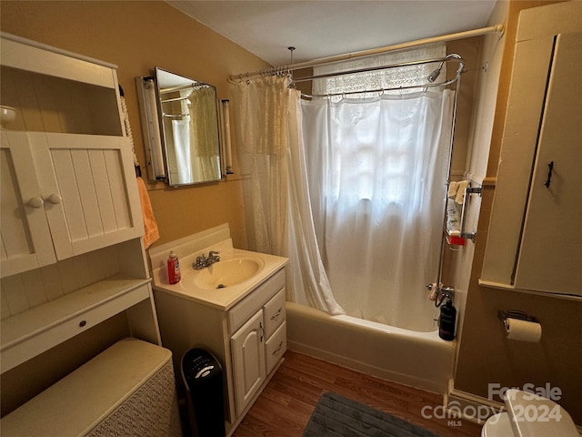 full bathroom featuring toilet, shower / tub combo, vanity, and hardwood / wood-style floors