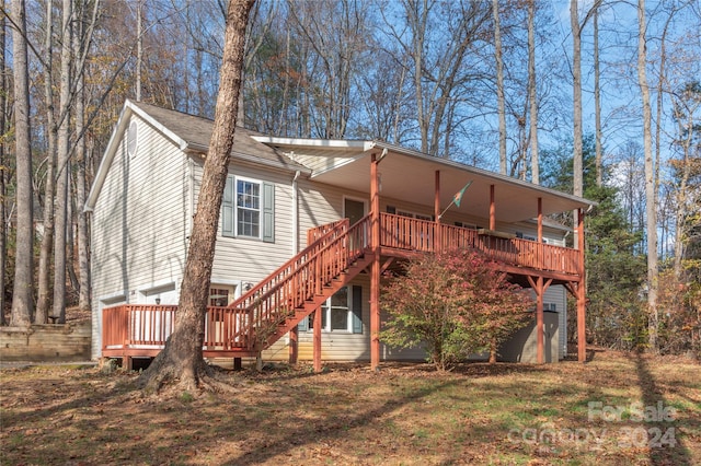 back of property featuring a wooden deck