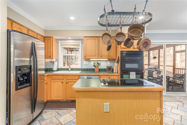 kitchen featuring a wealth of natural light, black appliances, sink, and a center island