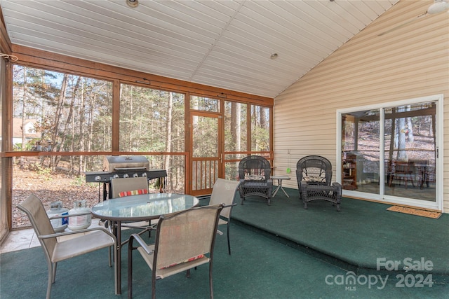 sunroom featuring vaulted ceiling and wooden ceiling