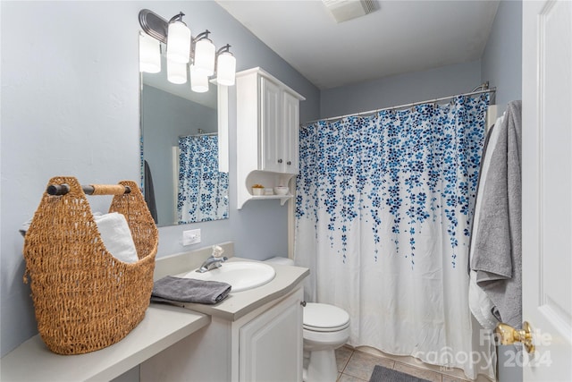 bathroom with vanity, tile patterned floors, and toilet