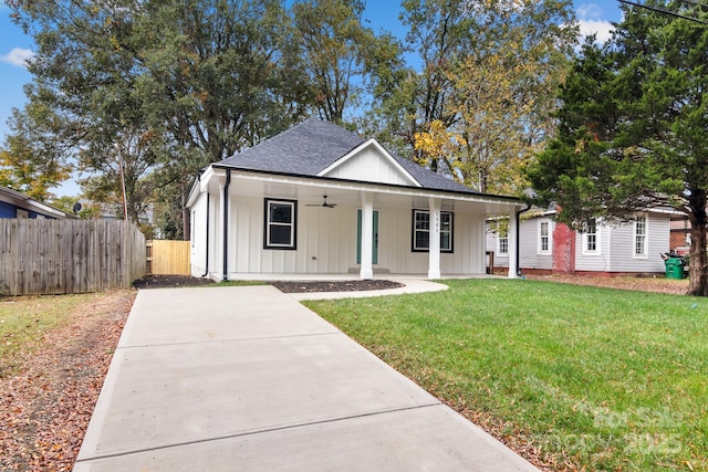 view of front facade featuring covered porch and a front yard