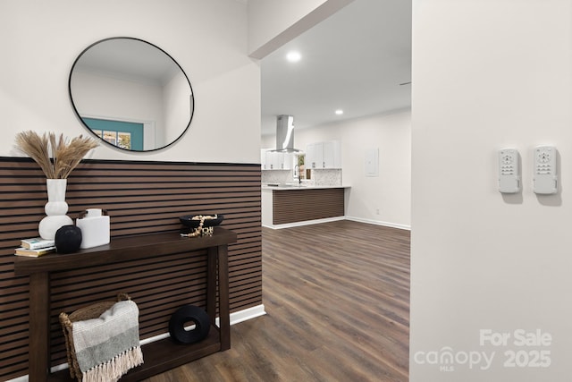 interior space with dark hardwood / wood-style floors, ornamental molding, sink, and electric panel