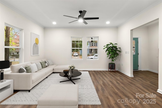 living room featuring dark hardwood / wood-style flooring, ceiling fan, and crown molding