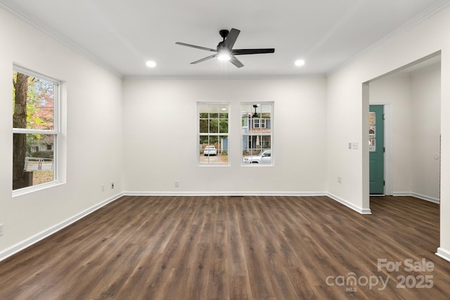 spare room featuring dark hardwood / wood-style flooring, plenty of natural light, and ornamental molding