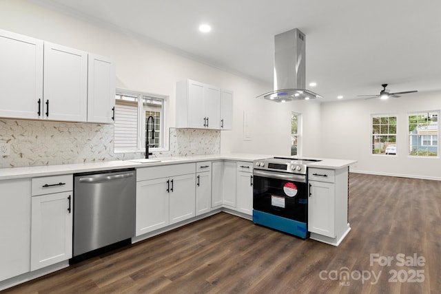 kitchen featuring white cabinetry, backsplash, island exhaust hood, kitchen peninsula, and appliances with stainless steel finishes