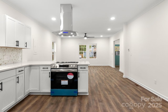 kitchen featuring stainless steel range with electric stovetop, ceiling fan, white cabinetry, kitchen peninsula, and island exhaust hood