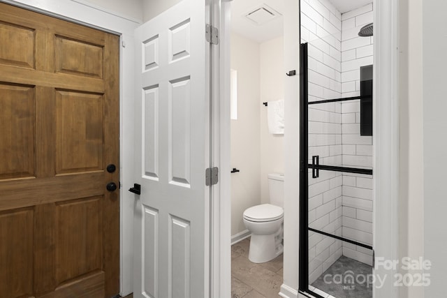 bathroom with an enclosed shower and toilet