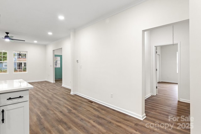 interior space featuring ceiling fan, crown molding, white cabinets, and dark hardwood / wood-style floors