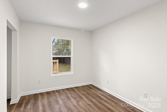 empty room featuring dark hardwood / wood-style flooring