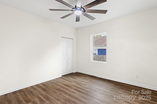 unfurnished room featuring ceiling fan and dark hardwood / wood-style floors