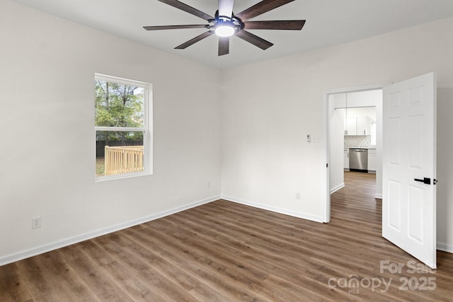 spare room featuring dark hardwood / wood-style floors and ceiling fan