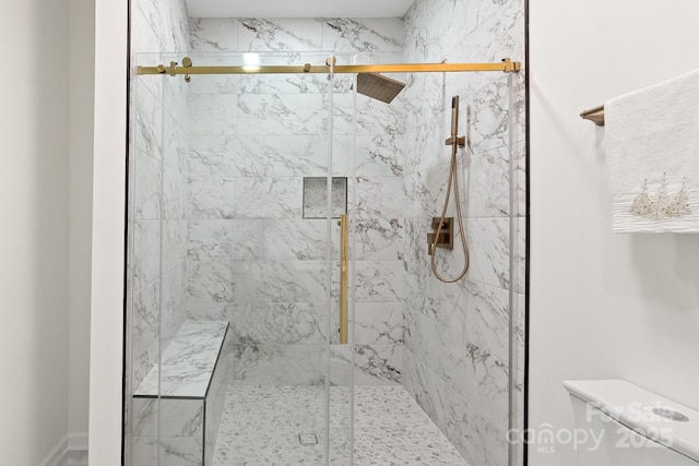 bathroom featuring toilet and an enclosed shower