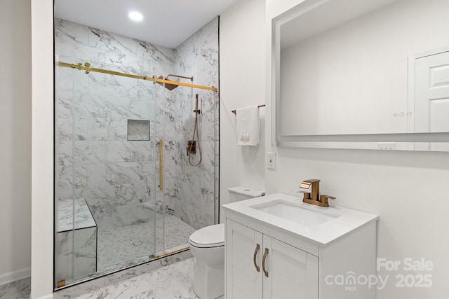 bathroom featuring vanity, toilet, and a shower with shower door