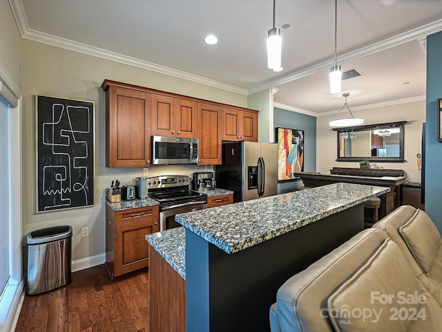 kitchen featuring stainless steel appliances, light stone counters, a kitchen breakfast bar, hanging light fixtures, and dark wood-type flooring