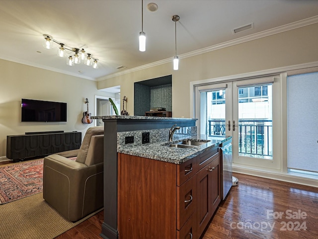 kitchen with ornamental molding, dark wood-type flooring, sink, and decorative light fixtures