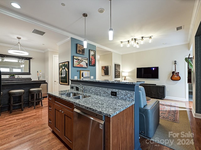 kitchen featuring ornamental molding, dark hardwood / wood-style floors, sink, dishwasher, and dark stone countertops