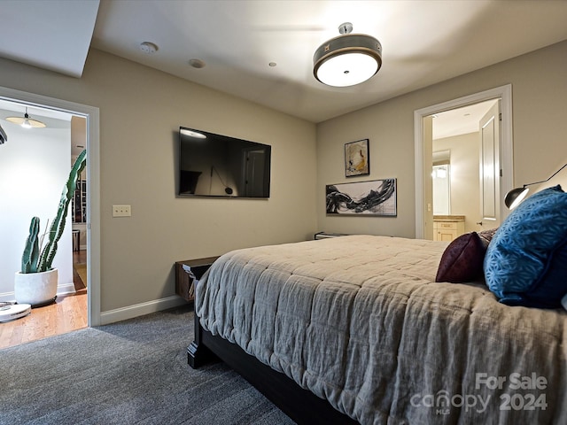 carpeted bedroom featuring ensuite bath