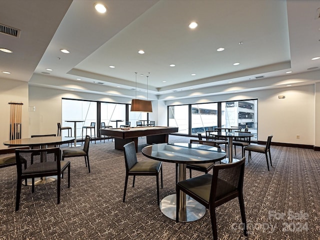 dining space with dark colored carpet, billiards, and a tray ceiling