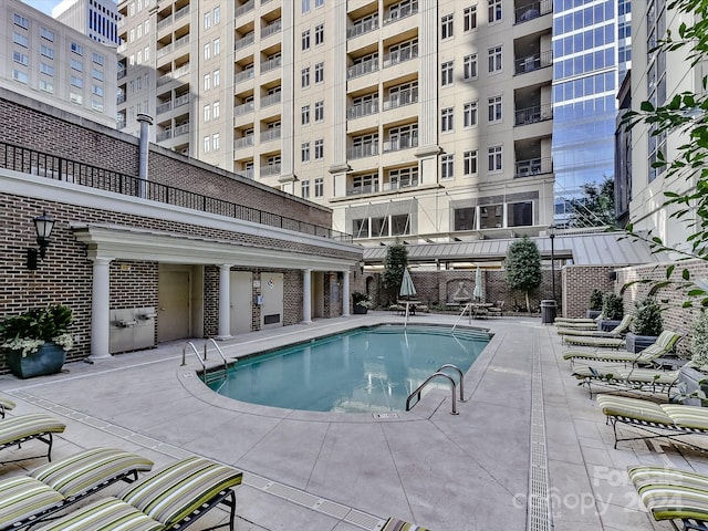 view of swimming pool featuring a patio