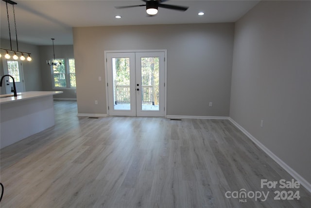 interior space with plenty of natural light, light hardwood / wood-style floors, and french doors