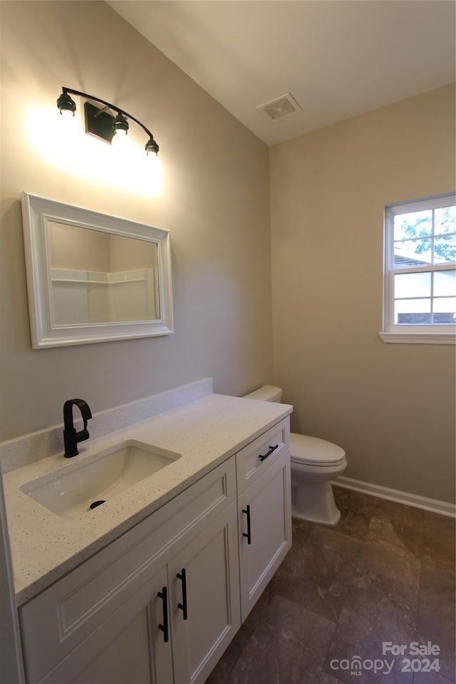 bathroom featuring vanity and toilet