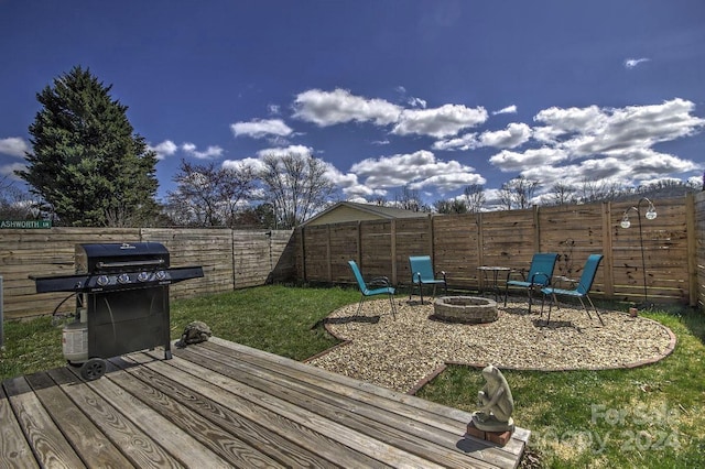 exterior space with a grill, a fire pit, and a lawn