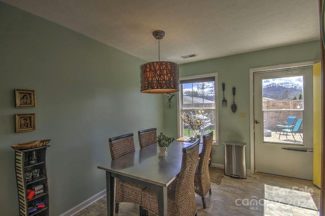 dining space featuring a textured ceiling