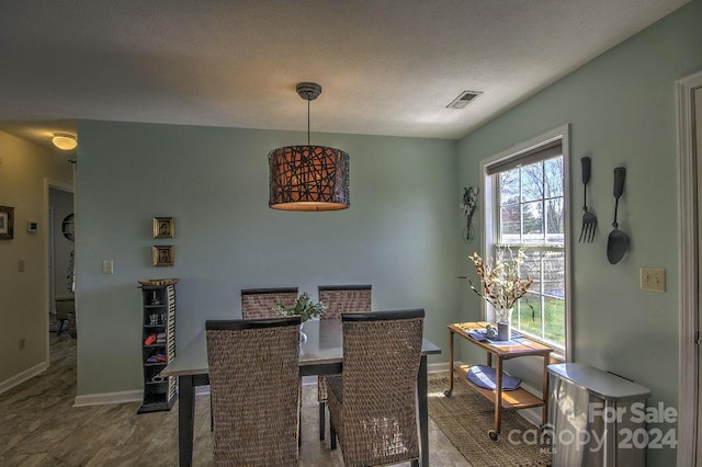 dining room featuring a textured ceiling