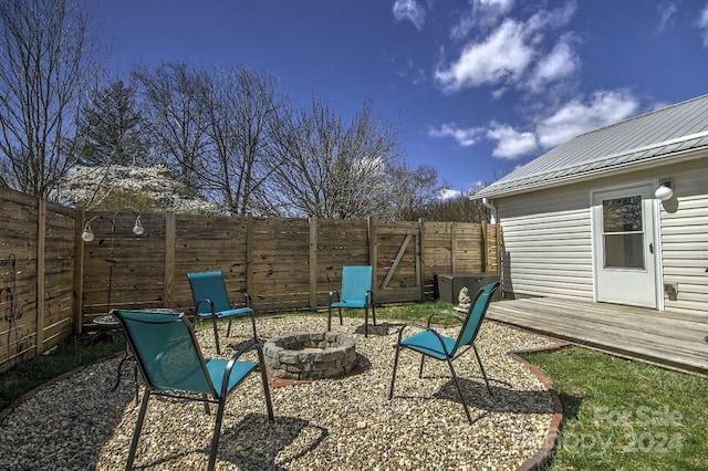 view of patio with an outdoor fire pit and a wooden deck