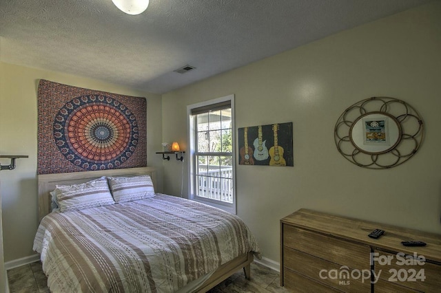 bedroom featuring a textured ceiling