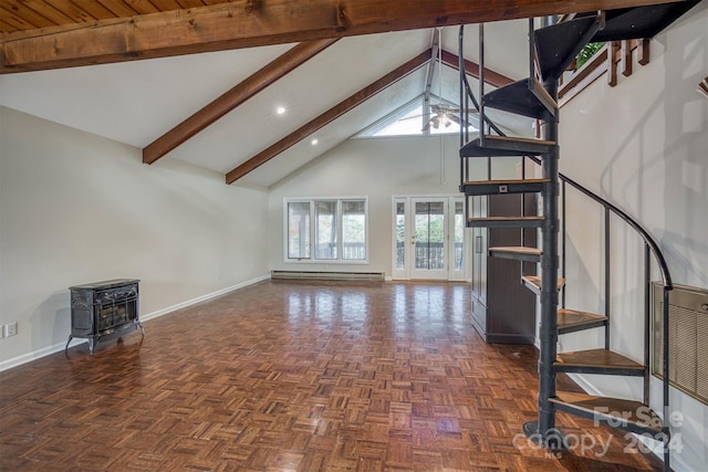 33 Summit Ln, Newland, NC 28657 - unfurnished living room with high vaulted ceiling, baseboards, beam ceiling, a wood stove, and plenty of natural light