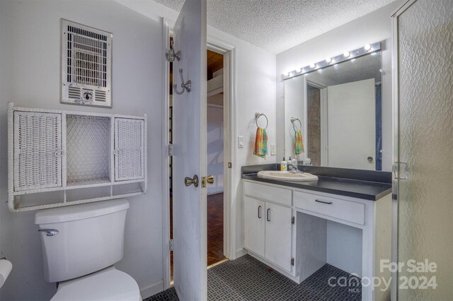 33 Summit Ln, Newland, NC 28657 - bathroom featuring toilet, vanity, and a textured ceiling