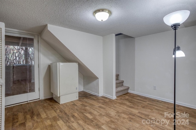 33 Summit Ln, Newland, NC 28657 - additional living space featuring wood finished floors, a textured ceiling, stairs, and baseboards