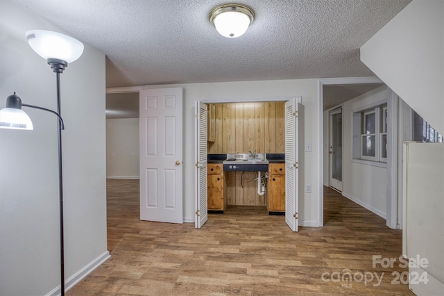 33 Summit Ln, Newland, NC 28657 - kitchen with wood finished floors, a textured ceiling, a sink, baseboards, and freestanding refrigerator