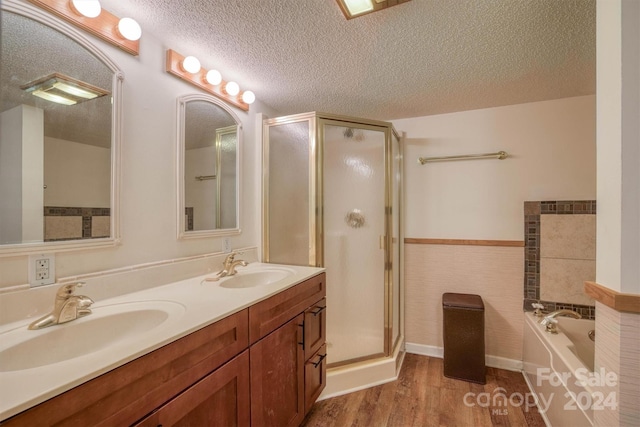 33 Summit Ln, Newland, NC 28657 - full bath with wood finished floors, a stall shower, double vanity, a bath, and a wainscoted wall